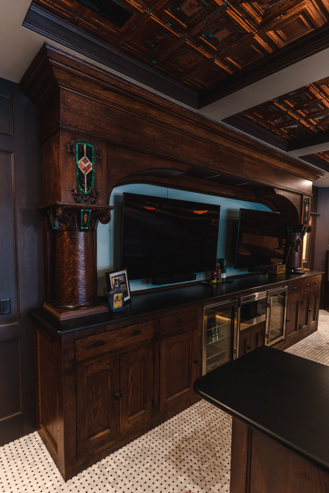 Inspiration for an expansive arts and crafts u-shaped seated home bar in Other with an undermount sink, shaker cabinets, medium wood cabinets, quartz benchtops, porcelain floors, white floor and black benchtop.