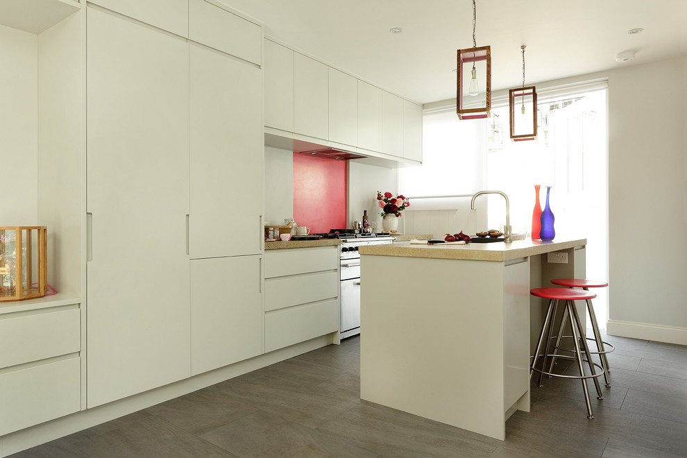 Design ideas for a mid-sized contemporary kitchen in London with an undermount sink, flat-panel cabinets, white cabinets, pink splashback, panelled appliances and with island.