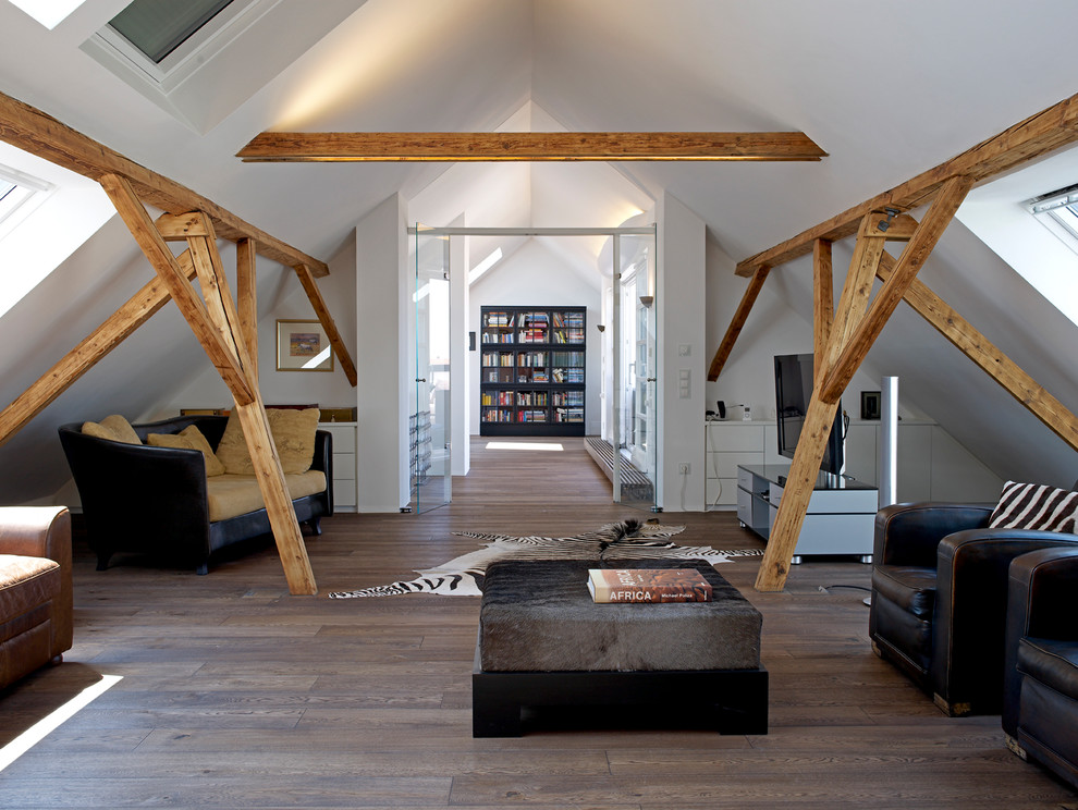 Inspiration for a large contemporary loft-style family room in Munich with a library, white walls, dark hardwood floors, a wood stove, a plaster fireplace surround, a concealed tv and brown floor.