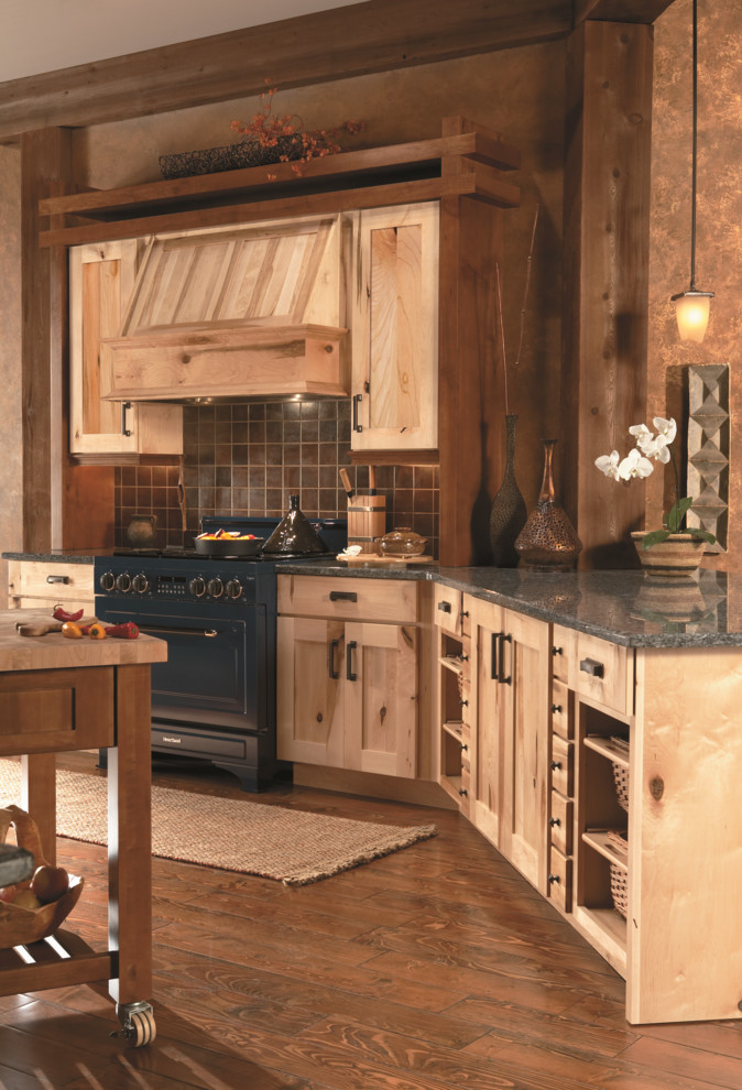 Large mountain style medium tone wood floor and brown floor kitchen photo in Baltimore with shaker cabinets, light wood cabinets, granite countertops, brown backsplash, colored appliances, an island and ceramic backsplash