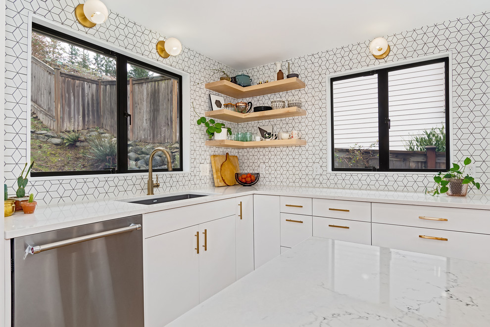 Inspiration for a contemporary l-shaped kitchen in Seattle with an undermount sink, flat-panel cabinets, white cabinets, white splashback, stainless steel appliances and with island.
