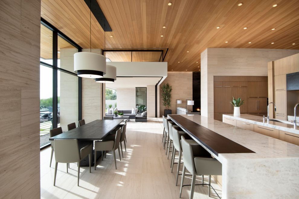 Example of a huge trendy limestone floor and wood ceiling eat-in kitchen design in Phoenix with an undermount sink, flat-panel cabinets, light wood cabinets, quartzite countertops, paneled appliances, two islands and white countertops