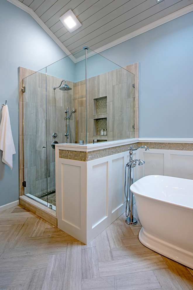This is an example of a mid-sized transitional master bathroom in Atlanta with raised-panel cabinets, medium wood cabinets, a freestanding tub, a corner shower, a two-piece toilet, metal tile, blue walls, limestone floors, a vessel sink, engineered quartz benchtops, grey floor, a hinged shower door, white benchtops, an enclosed toilet, a single vanity and timber.