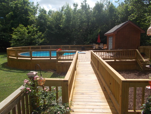  A surrounding deck that has a raised walkway to the pool area. It not only builds a nice pool area, but divides the yard into different spaces.