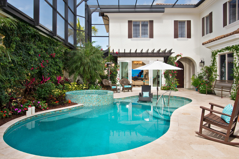 This is an example of a transitional backyard custom-shaped lap pool in Miami with a hot tub and tile.
