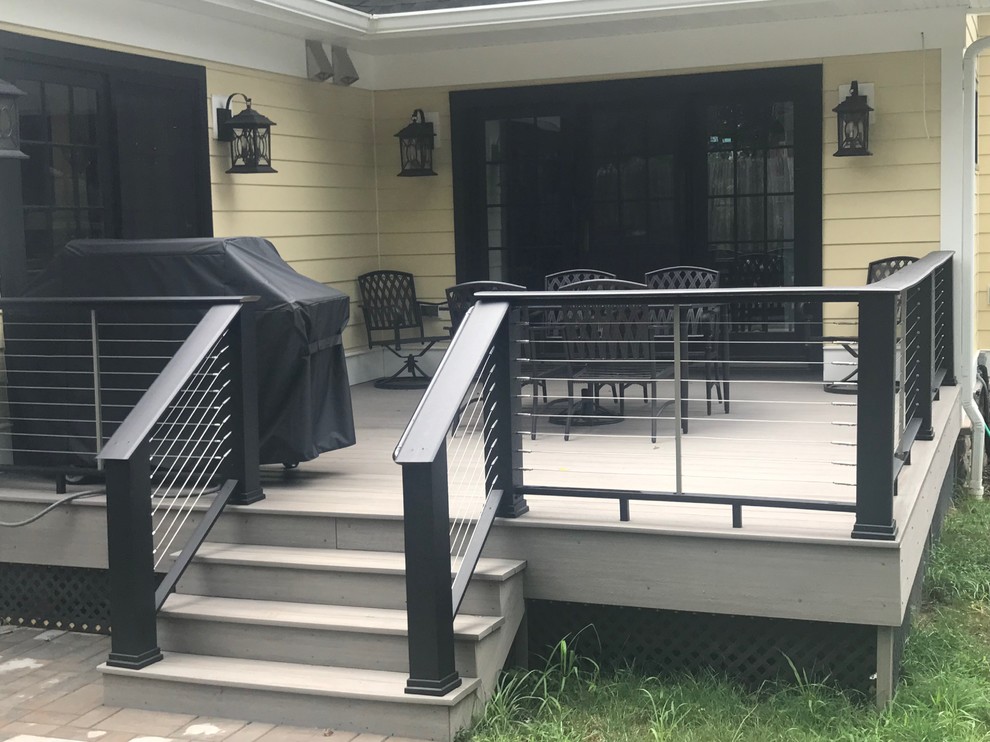 Deck - mid-sized transitional backyard deck idea in New York