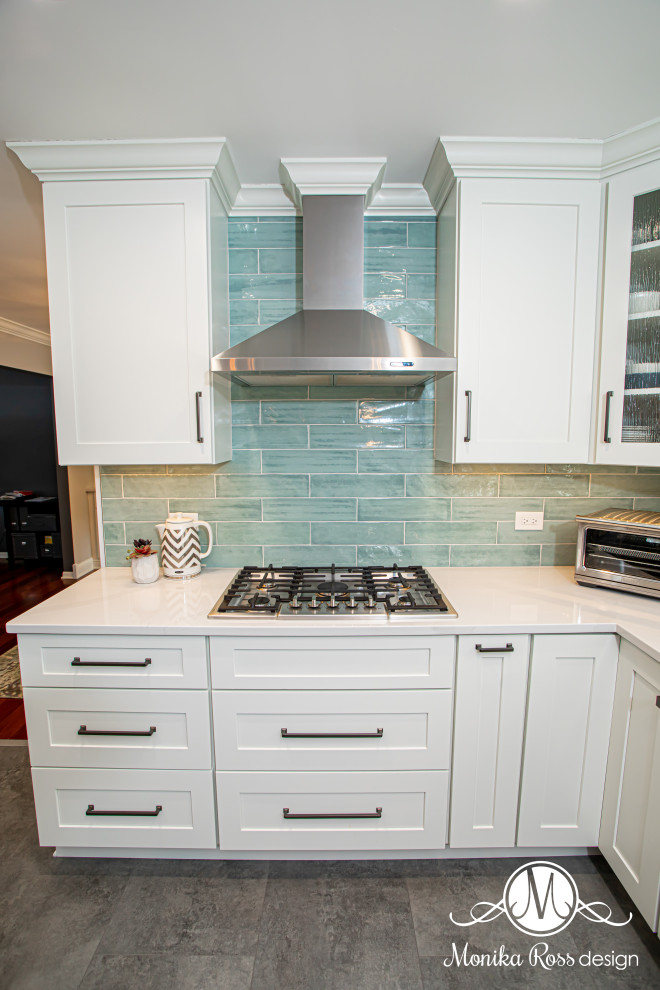 Eat-in kitchen - large coastal u-shaped vinyl floor and gray floor eat-in kitchen idea in Chicago with an undermount sink, shaker cabinets, white cabinets, quartz countertops, blue backsplash, ceramic backsplash, stainless steel appliances, an island and white countertops