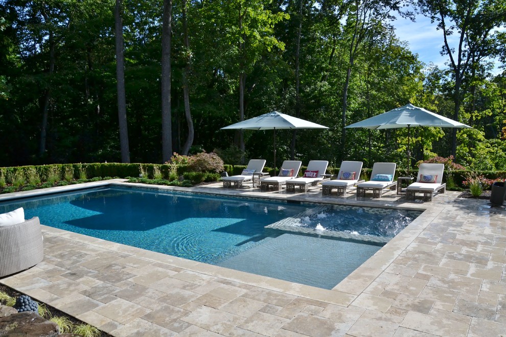 Large backyard stone and custom-shaped lap hot tub photo in New York