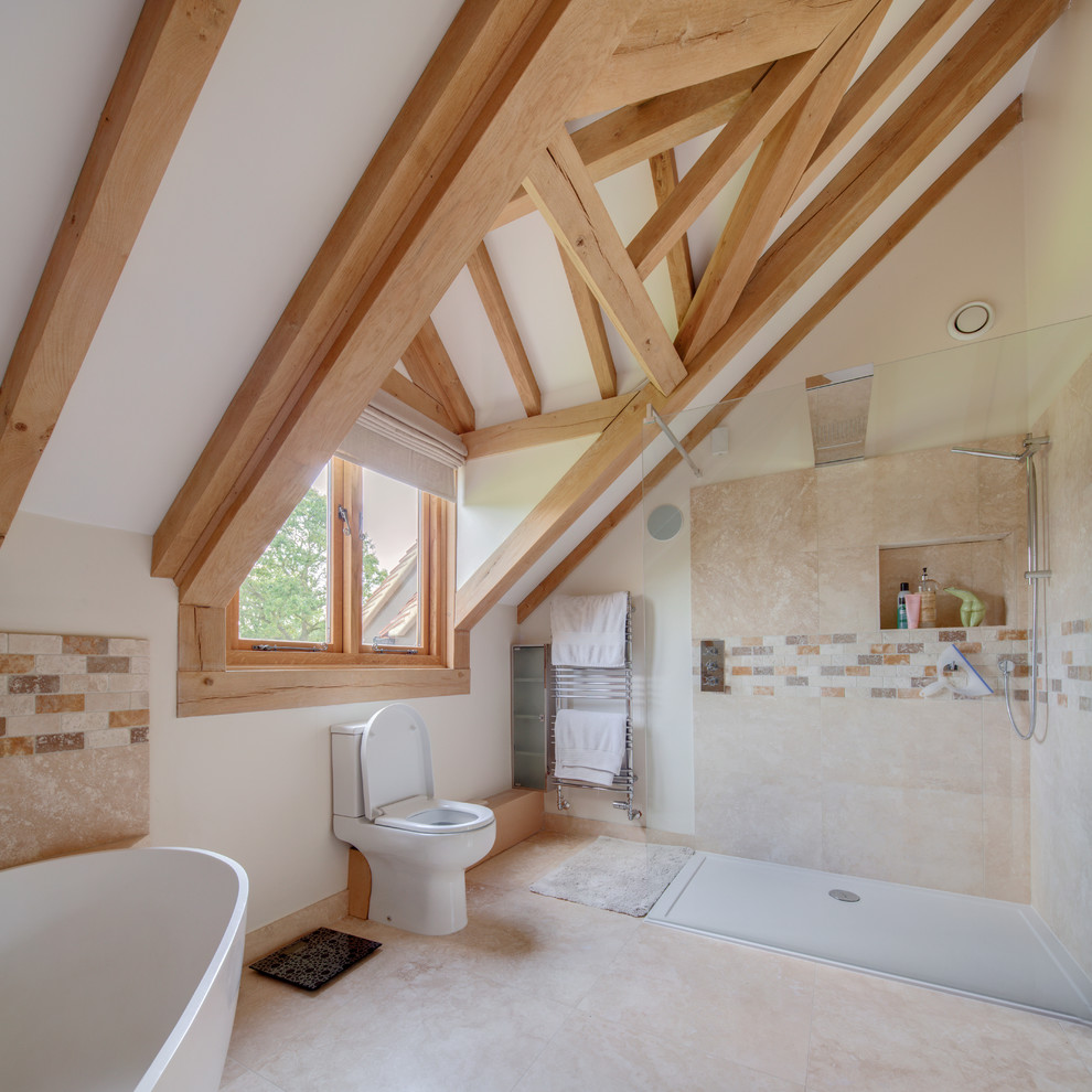 Design ideas for a country master bathroom in Surrey with a freestanding tub, a corner shower, a two-piece toilet, beige tile, brown tile, white walls and beige floor.