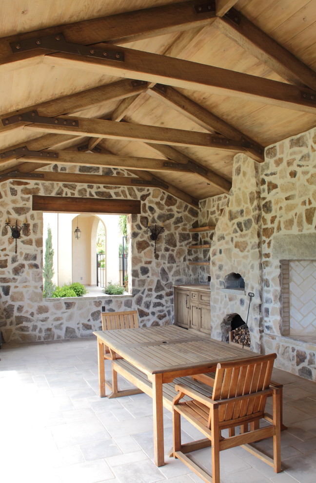 Photo of a traditional patio in San Francisco with a fire feature and a roof extension.