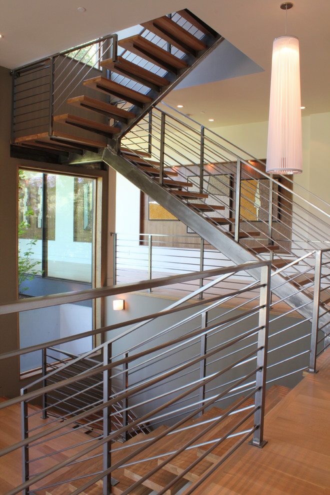Inspiration for a mid-sized contemporary wood floating staircase in San Francisco with metal risers.