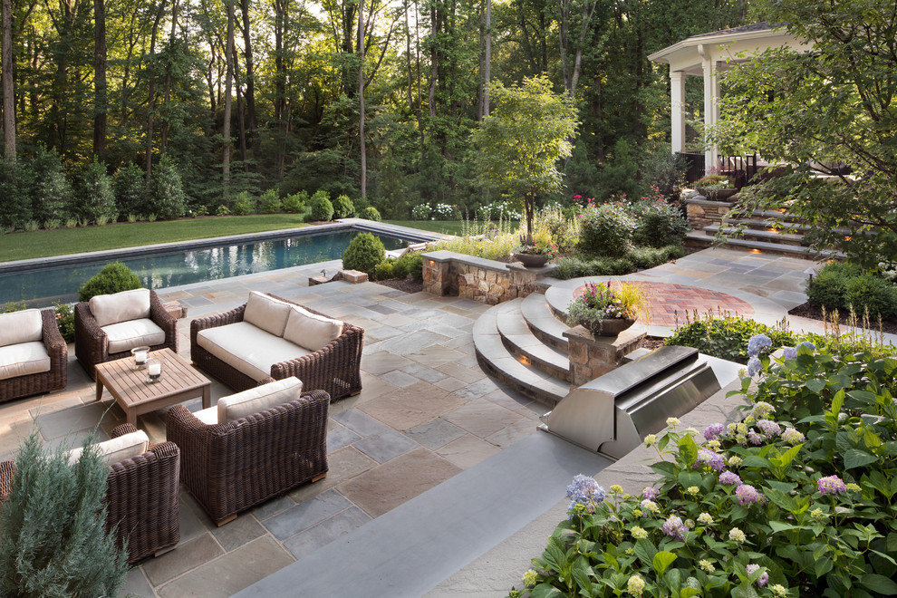 Design ideas for a large traditional backyard partial sun garden in DC Metro with natural stone pavers and a fire feature.