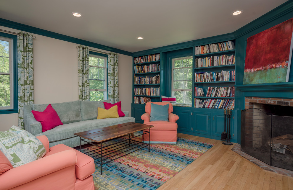 Mid-sized eclectic formal enclosed living room in Boston with light hardwood floors, a corner fireplace, a brick fireplace surround, brown floor, multi-coloured walls and no tv.