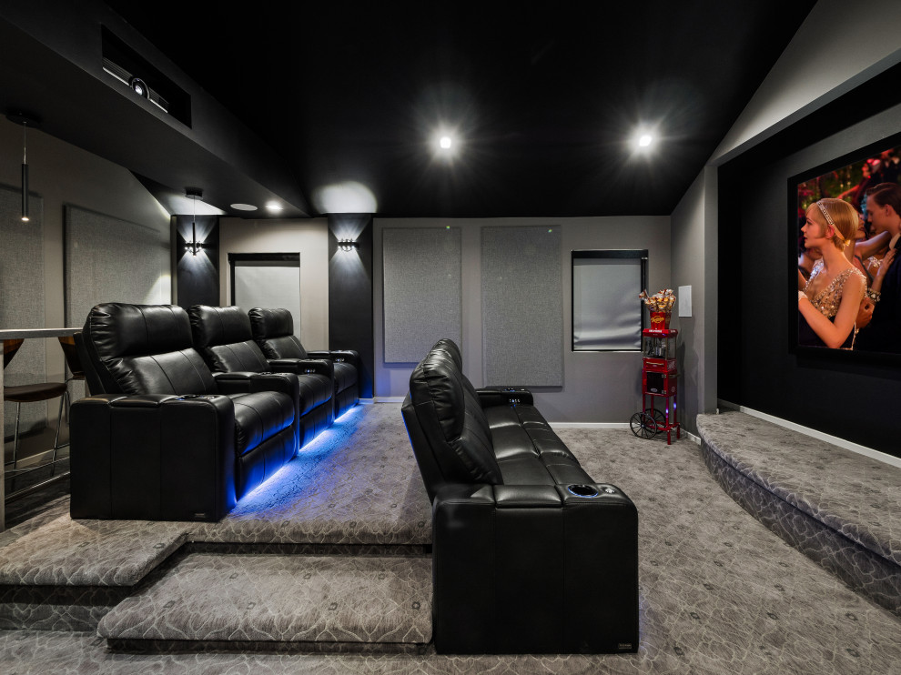Contemporary enclosed home theatre in Los Angeles with grey walls, carpet, a projector screen and grey floor.