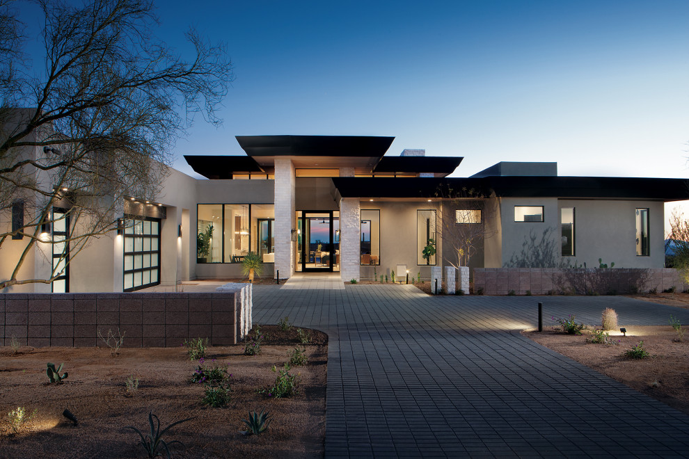 Inspiration for a contemporary one-storey stucco house exterior in Phoenix with a flat roof.