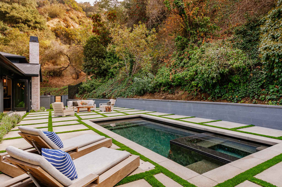 Inspiration for a country backyard rectangular natural pool in Los Angeles with concrete pavers.