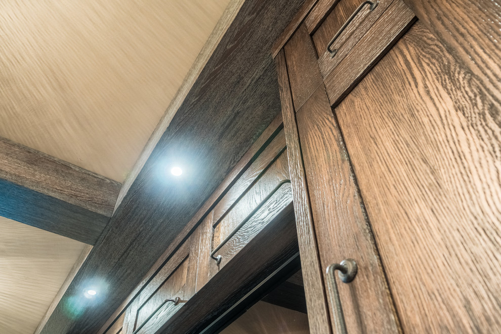 Large mountain style walk-out medium tone wood floor and brown floor basement photo in Calgary with gray walls