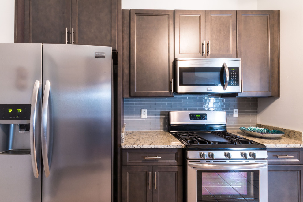 Eat-in kitchen - small galley cement tile floor and beige floor eat-in kitchen idea with an undermount sink, flat-panel cabinets, gray cabinets, granite countertops, gray backsplash, glass tile backsplash, stainless steel appliances, no island and white countertops