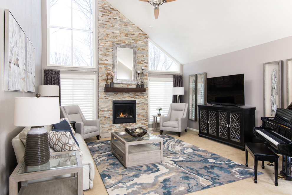 Large transitional enclosed living room in Detroit with grey walls, carpet, a standard fireplace, a stone fireplace surround, beige floor and a freestanding tv.