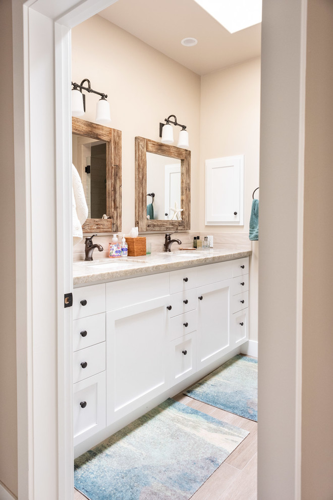Design ideas for a small arts and crafts 3/4 bathroom in San Luis Obispo with shaker cabinets, white cabinets, beige walls, a drop-in sink, granite benchtops, brown floor, beige benchtops and ceramic floors.