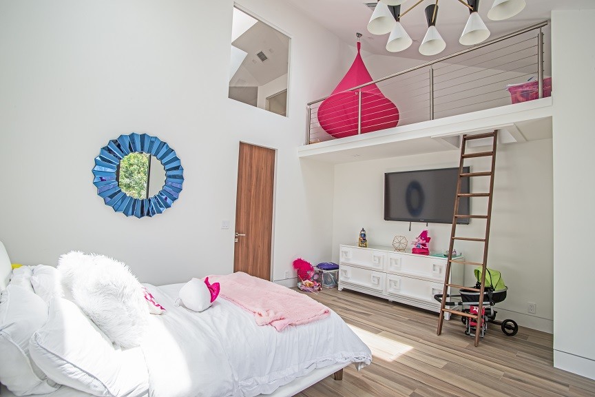 Inspiration for a large contemporary kids' bedroom for kids 4-10 years old and girls in Tampa with white walls, light hardwood floors and beige floor.