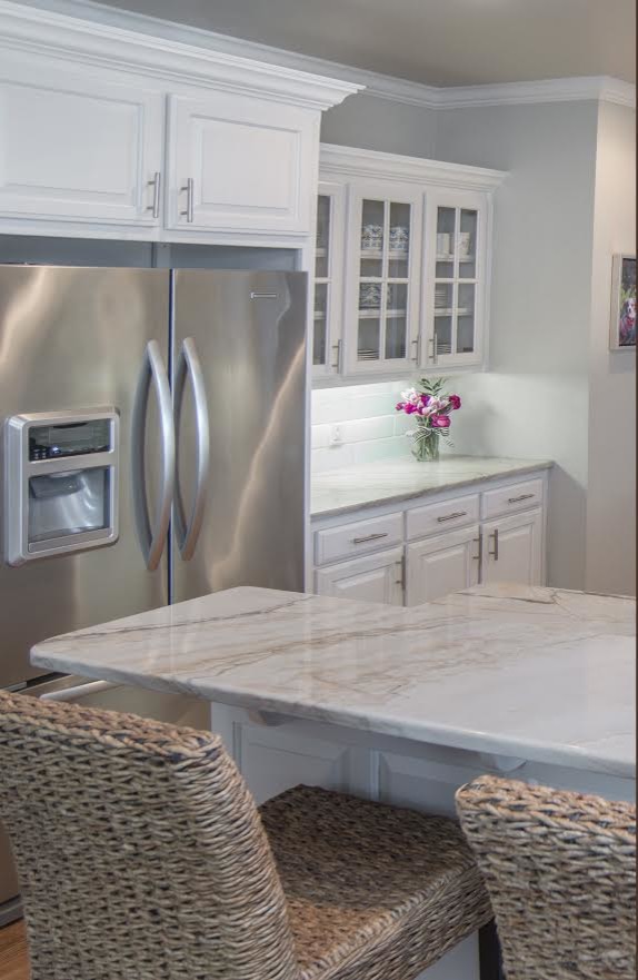 Example of a large transitional u-shaped light wood floor open concept kitchen design with a double-bowl sink, raised-panel cabinets, white cabinets, granite countertops, yellow backsplash, ceramic backsplash, stainless steel appliances and a peninsula