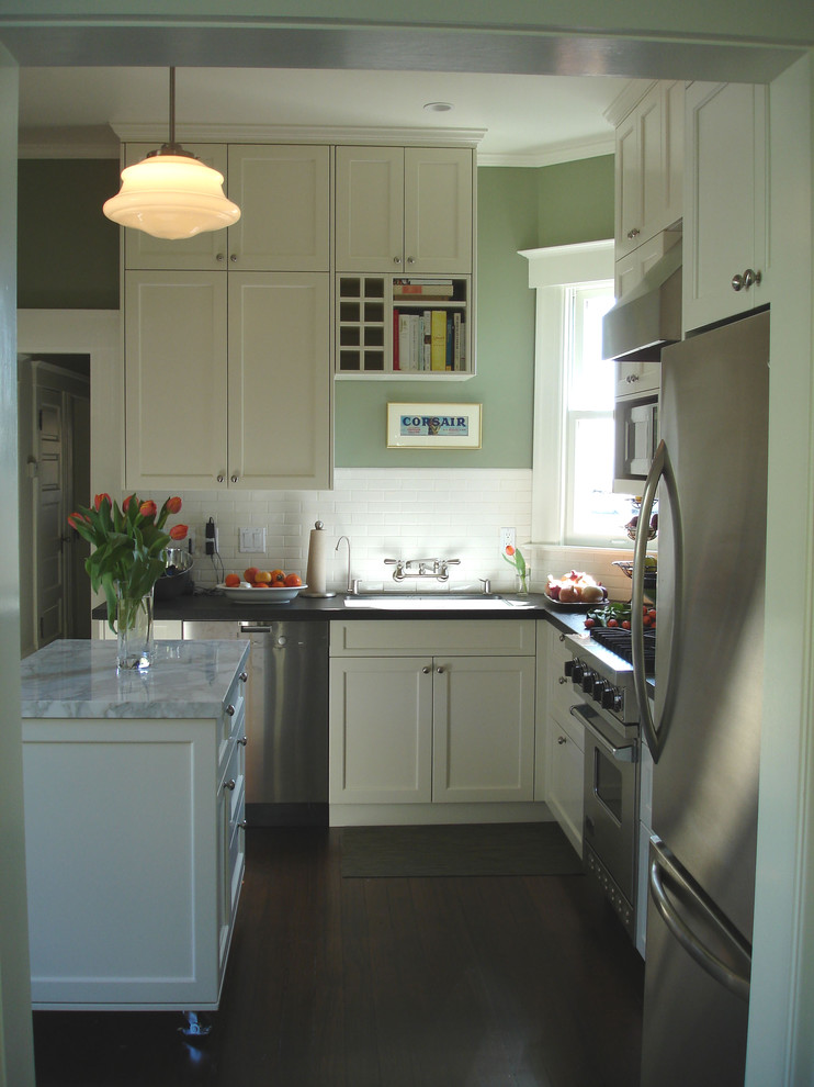 This is an example of a traditional kitchen in San Francisco with subway tile splashback and marble benchtops.