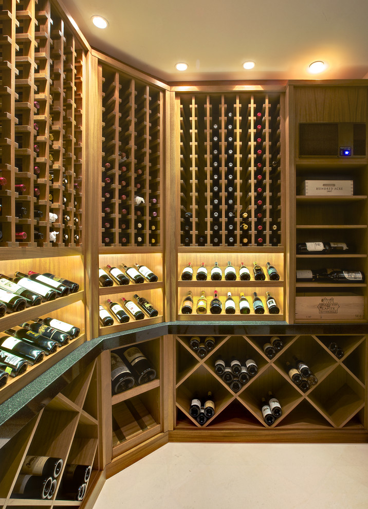 This is an example of a large transitional wine cellar in Salt Lake City with limestone floors and display racks.