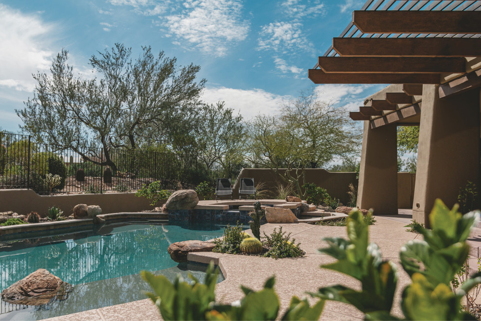 This is an example of a contemporary backyard pool in Phoenix with with a pool.
