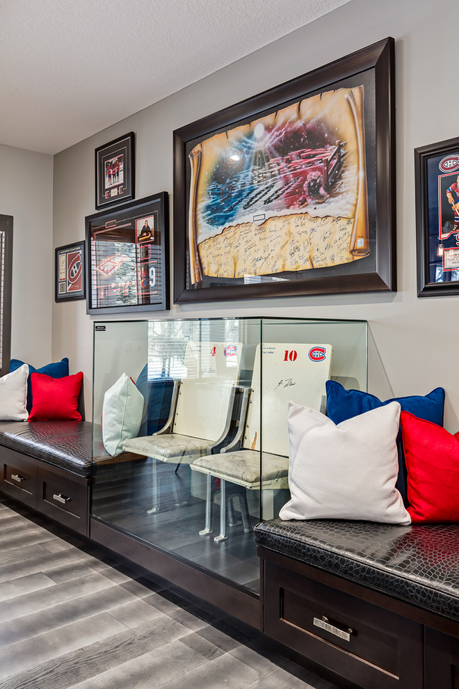 Basement - large transitional walk-out medium tone wood floor and gray floor basement idea in Calgary with gray walls