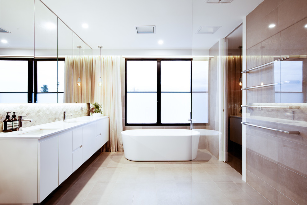 Inspiration for a mid-sized contemporary bathroom in Melbourne with raised-panel cabinets, an open shower, beige tile, stone tile, white walls, travertine floors, an undermount sink, quartzite benchtops, grey floor and white benchtops.