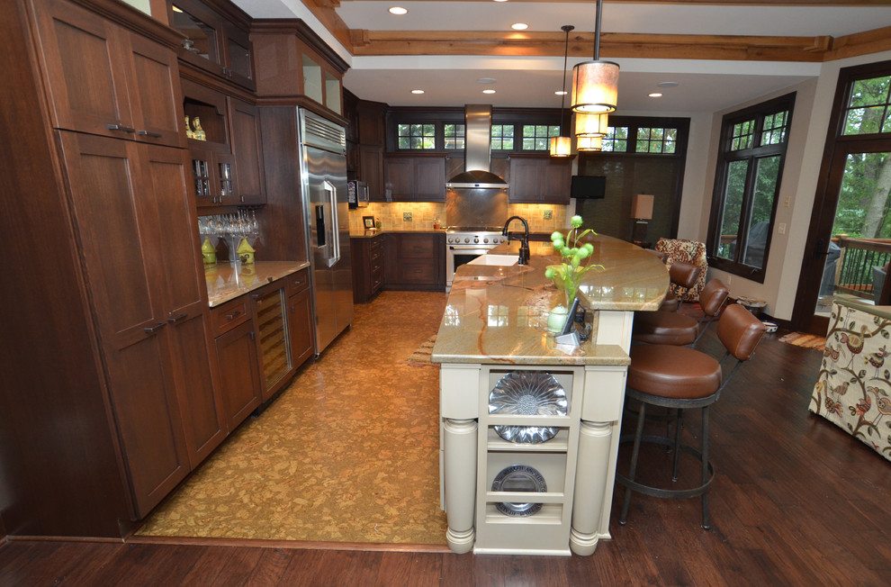 Inspiration for a huge transitional cork floor eat-in kitchen remodel in Milwaukee with a farmhouse sink, flat-panel cabinets, medium tone wood cabinets, granite countertops, stone tile backsplash, stainless steel appliances and an island