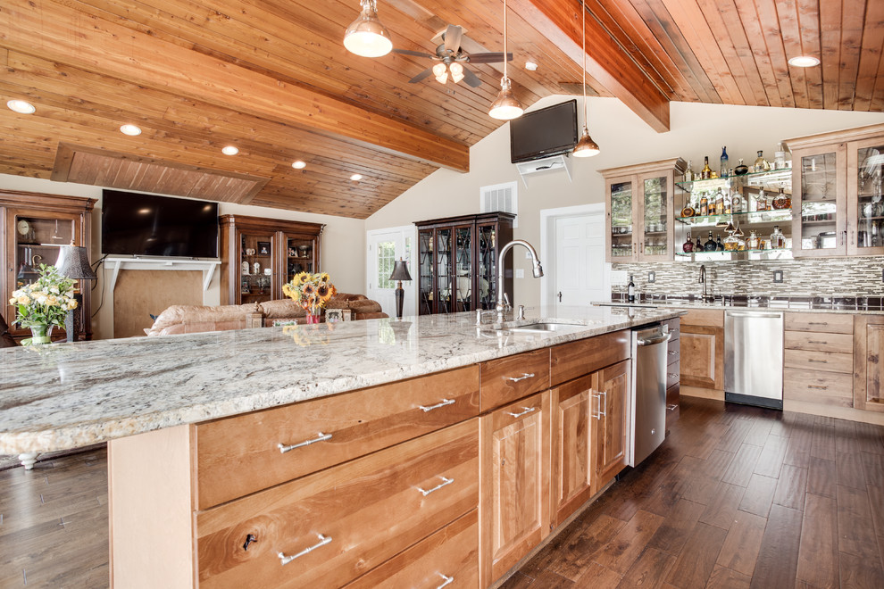 Large mountain style kitchen photo in DC Metro with an undermount sink, raised-panel cabinets, granite countertops, glass tile backsplash, stainless steel appliances and an island