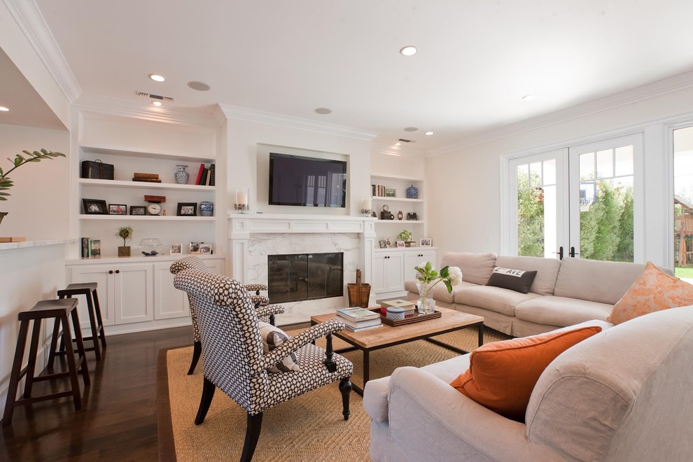 Photo of a traditional open concept family room in Orange County with a standard fireplace and a wall-mounted tv.
