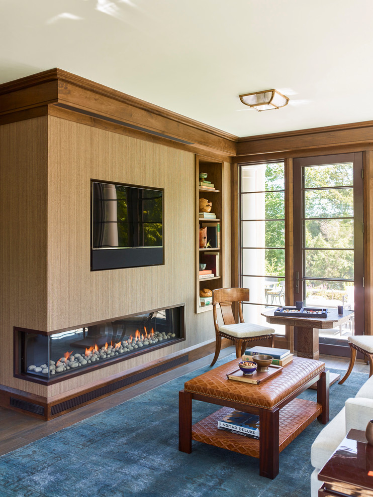 This is an example of a large traditional study room in Boston with brown walls, dark hardwood floors, a corner fireplace, a metal fireplace surround, a freestanding desk and brown floor.
