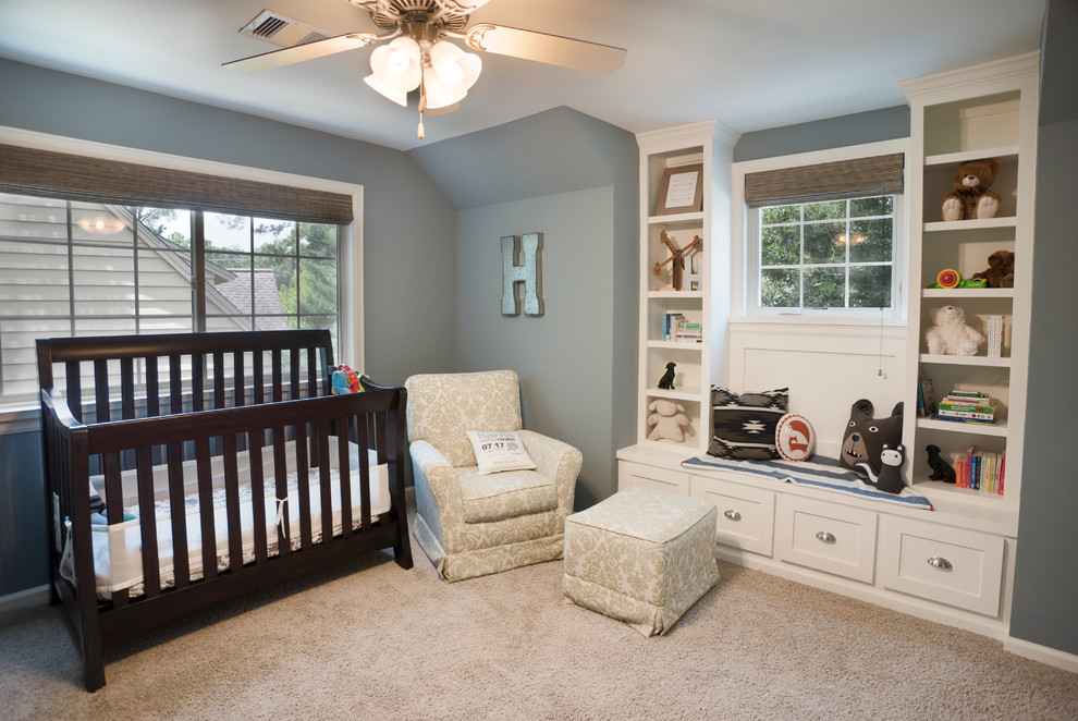 Photo of a mid-sized traditional nursery for boys in Houston with blue walls and carpet.