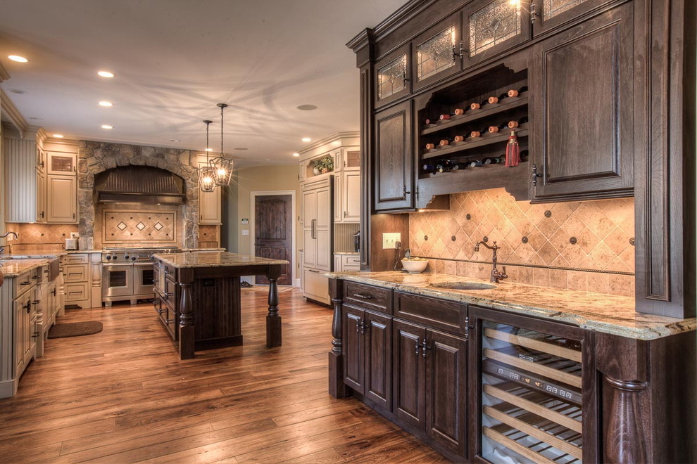 Example of a mountain style kitchen design in Boston with raised-panel cabinets, beige cabinets, granite countertops, beige backsplash, an island and beige countertops