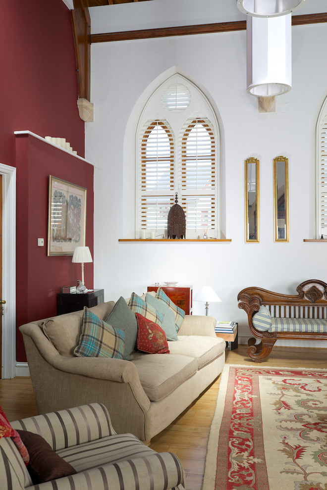 This is an example of a large country open concept living room in Dorset with light hardwood floors.