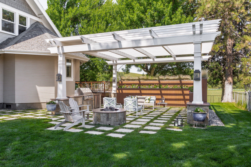 This is an example of a large transitional side yard patio in Seattle with a fire feature, concrete pavers and a pergola.