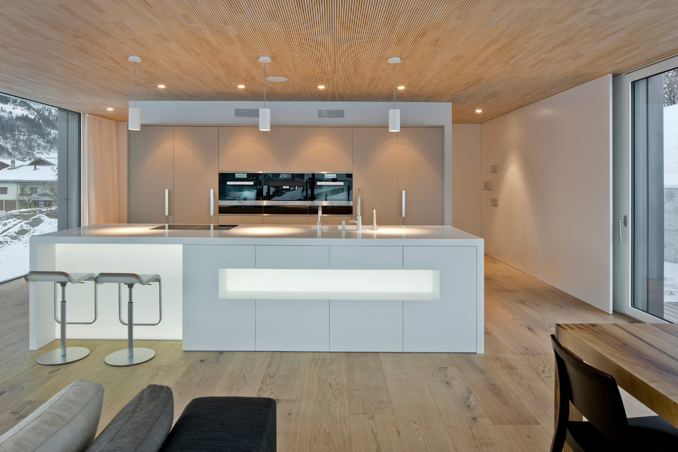 Photo of a modern kitchen in Other with an integrated sink and solid surface benchtops.