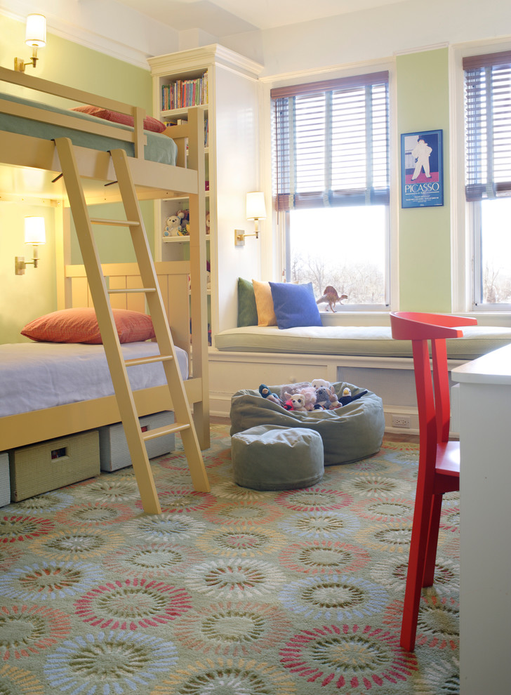 This is an example of a mid-sized traditional gender-neutral kids' bedroom for kids 4-10 years old in New York with green walls and medium hardwood floors.