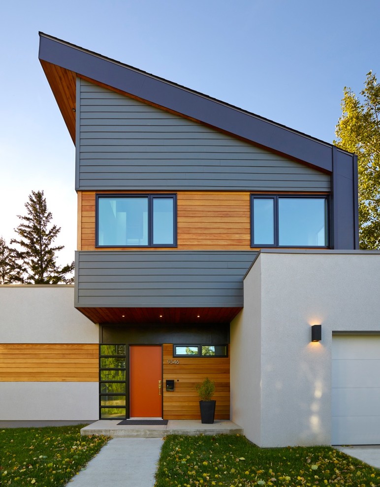 Inspiration for a contemporary two-storey exterior in Edmonton with mixed siding and a shed roof.
