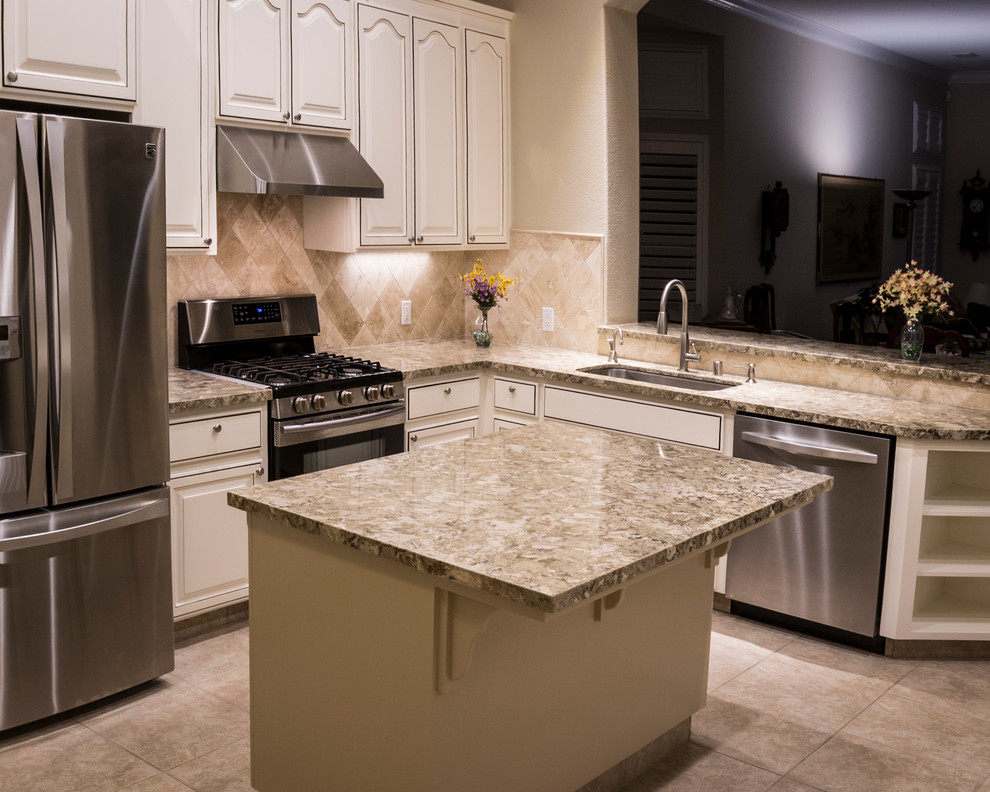 Design ideas for a large transitional l-shaped separate kitchen in Sacramento with an undermount sink, raised-panel cabinets, white cabinets, granite benchtops, beige splashback, stone tile splashback, stainless steel appliances, ceramic floors, with island and beige floor.
