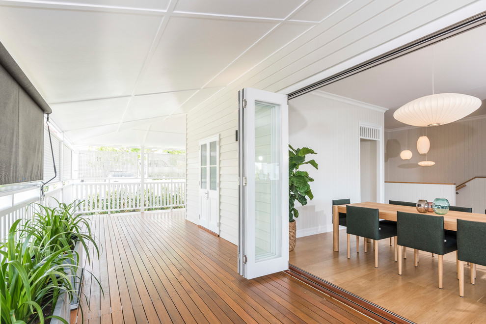 Transitional backyard deck in Brisbane with a roof extension.