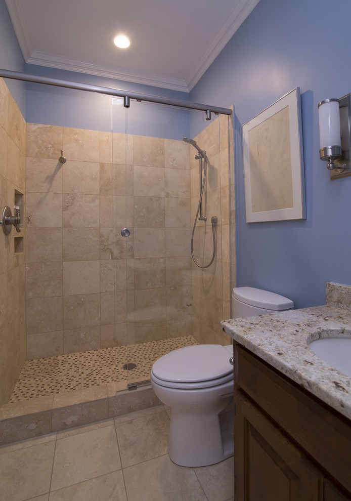 Inspiration for a small transitional 3/4 bathroom in Raleigh with raised-panel cabinets, dark wood cabinets, an alcove shower, a two-piece toilet, beige tile, blue walls, travertine floors, an undermount sink, granite benchtops, travertine, beige floor, a sliding shower screen and white benchtops.