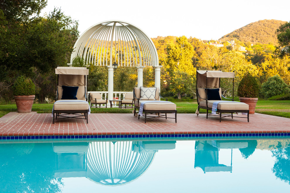 Pool - huge transitional backyard brick and rectangular pool idea in San Diego
