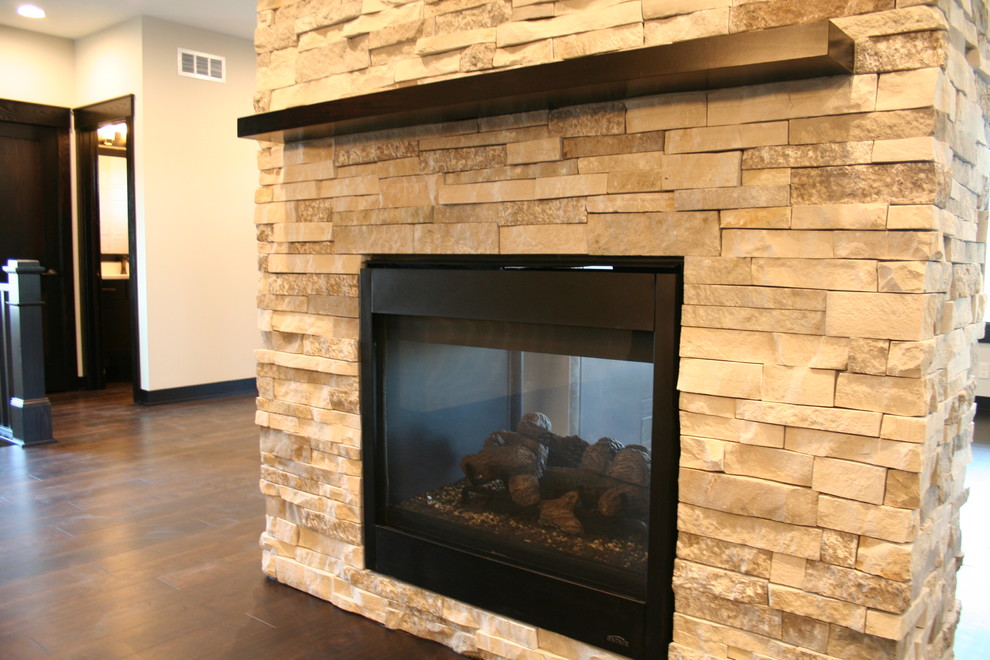 Mid-sized transitional dark wood floor and brown floor kitchen/dining room combo photo with beige walls, a two-sided fireplace and a stone fireplace