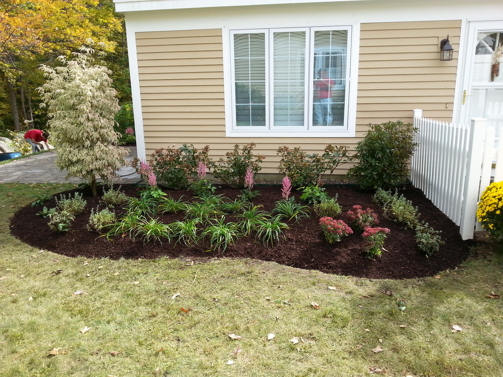 Small traditional front yard full sun formal garden in Boston with concrete pavers.