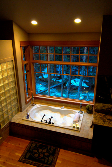 Large mountain style master beige tile and ceramic tile light wood floor drop-in bathtub photo