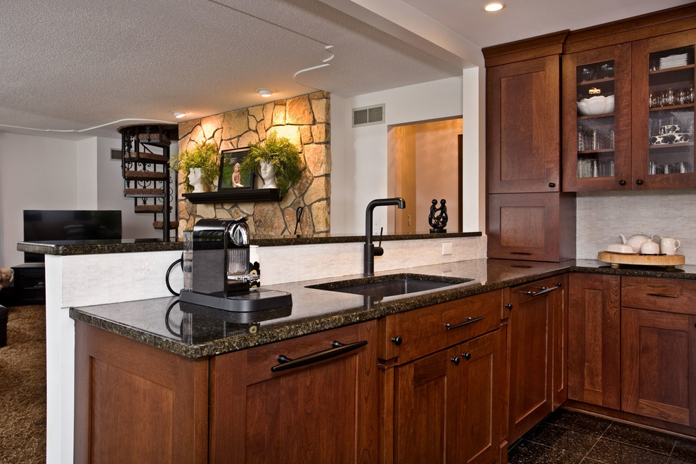 Transitional kitchen in Minneapolis with an undermount sink, dark wood cabinets, granite benchtops, stone tile splashback, panelled appliances, marble floors and multi-coloured benchtop.